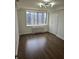 Bright bedroom features hardwood floors, large window, and neutral paint at 2479 Peachtree Ne Rd # 902, Atlanta, GA 30305