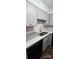 Bright kitchen featuring white cabinets, stainless steel sink, and black dishwasher at 2479 Peachtree Ne Rd # 902, Atlanta, GA 30305