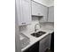 Modern kitchen with stainless steel sink, gray cabinets, and quartz countertops at 2479 Peachtree Ne Rd # 902, Atlanta, GA 30305