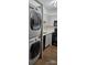 Efficient kitchen with stackable washer/dryer, white cabinets, and black appliances at 2479 Peachtree Ne Rd # 902, Atlanta, GA 30305