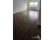 This living room features gleaming hardwood flooring and a large window offering plenty of natural light at 2479 Peachtree Ne Rd # 902, Atlanta, GA 30305