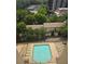 An aerial view showcases a sparkling pool surrounded by lush trees and lounge chairs at 2479 Peachtree Ne Rd # 902, Atlanta, GA 30305