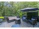 Large back deck with seating and an umbrella for shade at 3648 Sope Creek Farm Se, Marietta, GA 30067