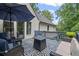 Large back deck with seating and an umbrella for shade at 3648 Sope Creek Farm Se, Marietta, GA 30067