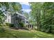 Expansive backyard with multi-level decks, screened porch, and lush greenery, ideal for outdoor living at 3648 Sope Creek Farm Se, Marietta, GA 30067