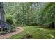 Lush backyard with a winding gravel path, perfect for enjoying nature and outdoor activities at 3648 Sope Creek Farm Se, Marietta, GA 30067
