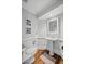 Bathroom featuring hardwood floors, a pedestal sink and decorative accents at 3648 Sope Creek Farm Se, Marietta, GA 30067