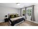 Bright bedroom with windows overlooking a peaceful wooded area at 3648 Sope Creek Farm Se, Marietta, GA 30067