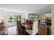 Dining room featuring hardwood floors and views of the porch through large windows at 3648 Sope Creek Farm Se, Marietta, GA 30067