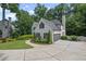 Stylish white home featuring a side-entry garage, manicured lawn, and elegant landscaping, creating a sophisticated look at 3648 Sope Creek Farm Se, Marietta, GA 30067