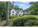 Well-maintained white home surrounded by mature trees and greenery, offering a peaceful and private setting at 3648 Sope Creek Farm Se, Marietta, GA 30067