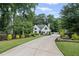 Elegant white home with an inviting driveway, lush landscaping, and well-maintained lawn, creating a serene atmosphere at 3648 Sope Creek Farm Se, Marietta, GA 30067