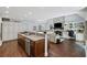 Open concept kitchen featuring granite countertops, stainless appliances, and views of the living room fireplace at 3648 Sope Creek Farm Se, Marietta, GA 30067