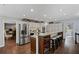 Spacious kitchen featuring stainless steel appliances, a large island with seating and hardwood floors at 3648 Sope Creek Farm Se, Marietta, GA 30067
