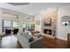 Cozy living room with stone fireplace, large windows, and comfortable seating, perfect for relaxation and gatherings at 3648 Sope Creek Farm Se, Marietta, GA 30067