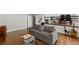Comfortable living room with hardwood floors and gray sofa adjacent to a staircase, perfect for relaxation at 3648 Sope Creek Farm Se, Marietta, GA 30067