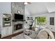 Living room featuring a stone fireplace, built-in shelves, and sliding doors to a deck at 3648 Sope Creek Farm Se, Marietta, GA 30067