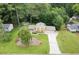Stunning aerial view of a home with a long driveway and landscaped lawn surrounded by lush trees at 423 Mephisto Cir, Lawrenceville, GA 30046
