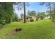 A spacious green backyard with a two-story home, featuring a lattice-covered porch and fenced yard at 423 Mephisto Cir, Lawrenceville, GA 30046
