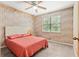Bedroom with wood paneled wallpaper, a ceiling fan and bright natural light at 423 Mephisto Cir, Lawrenceville, GA 30046