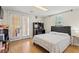 Bedroom with wooden floor, a black cushioned headboard bed, and glass doors to a patio at 423 Mephisto Cir, Lawrenceville, GA 30046
