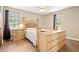 Bedroom with wood floors, ceiling fan, and bright natural light at 423 Mephisto Cir, Lawrenceville, GA 30046
