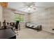 Bedroom with wood paneled wallpaper, a ceiling fan and bright natural light at 423 Mephisto Cir, Lawrenceville, GA 30046