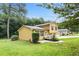Side view of a two-story home with an attached two-car garage and a well-maintained green lawn at 423 Mephisto Cir, Lawrenceville, GA 30046