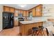 Well-appointed kitchen with wood cabinets, granite countertops, and modern black appliances at 423 Mephisto Cir, Lawrenceville, GA 30046