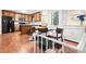Kitchen and dining area featuring hardwood floors, modern appliances, and stylish chandelier at 423 Mephisto Cir, Lawrenceville, GA 30046