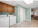 A well-lit laundry room with modern appliances and extra storage cabinets, enhanced by natural light at 423 Mephisto Cir, Lawrenceville, GA 30046