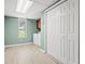 Functional laundry room with washer, dryer, storage cabinets, and a window for natural light at 423 Mephisto Cir, Lawrenceville, GA 30046