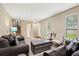 Inviting living room with plenty of natural light, stylish furnishings, and a cozy atmosphere at 423 Mephisto Cir, Lawrenceville, GA 30046