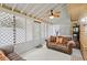 Inviting sunroom with comfortable seating, decorative fan, and lattice screen, perfect for relaxation at 423 Mephisto Cir, Lawrenceville, GA 30046