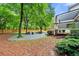Spacious backyard featuring a sitting area, fire pit, and mature trees at 6655 Manchester Pl, Cumming, GA 30040