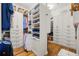 Custom closet featuring built-in cabinets and open shelving providing ample storage and organization at 6655 Manchester Pl, Cumming, GA 30040