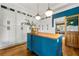 Bright kitchen featuring an island with seating, white cabinets, stylish pendant lights and hardwood floors at 6655 Manchester Pl, Cumming, GA 30040