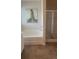 Bright bathroom featuring a tub and shower with tile flooring at 1028 Merritt Dr # 15, Villa Rica, GA 30180