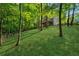 A lovely backyard with a slope and surrounded by mature trees at 1720 Little Willeo Rd, Marietta, GA 30068