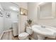 Cozy bathroom featuring a pedestal sink and toilet, with a laundry closet visible in the background at 1720 Little Willeo Rd, Marietta, GA 30068