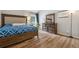Comfortable bedroom with wood-look floors, elegant furniture, and a window providing soft natural light at 1720 Little Willeo Rd, Marietta, GA 30068