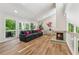 Bright living room with a cozy fireplace, large windows, and hardwood floors, open to the second story at 1720 Little Willeo Rd, Marietta, GA 30068