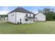Expansive backyard featuring lush green lawn and covered patio, perfect for outdoor entertaining at 291 Sandy Oak Dr, Loganville, GA 30052