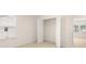 Sun-filled bedroom with blinds, closet and open entry to the hallway at 291 Sandy Oak Dr, Loganville, GA 30052