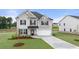 Beautiful two-story home boasts a brick facade, well-manicured lawn, and a spacious two-car garage at 291 Sandy Oak Dr, Loganville, GA 30052