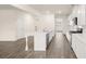 This updated kitchen offers an island, stainless appliances, white cabinets, and hardwood floors at 291 Sandy Oak Dr, Loganville, GA 30052
