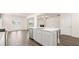 Kitchen island with stainless steel dishwasher, stone countertop, and view into living area at 291 Sandy Oak Dr, Loganville, GA 30052