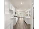 This modern kitchen features white cabinets, stainless appliances, and a large island at 291 Sandy Oak Dr, Loganville, GA 30052