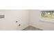 Bright laundry room showcasing hookups and a window with neighborhood views at 291 Sandy Oak Dr, Loganville, GA 30052