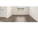 A sunlit room with a large window, hardwood floors, and neutral paint to welcome you home at 291 Sandy Oak Dr, Loganville, GA 30052
